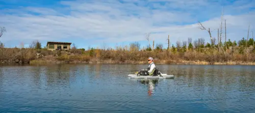 Angler fishing from a float tube with the cabin in the background at Rock Creek Lake - Bryan Quick photo
