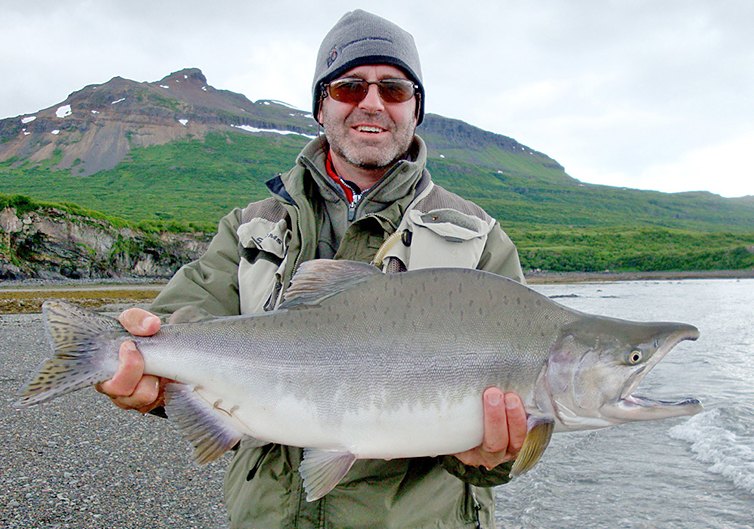 Angler holding a male pink salmon