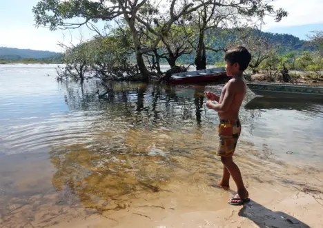 Kayapo boy down at the waters edge at Xingu - Rodrigo Salles photo