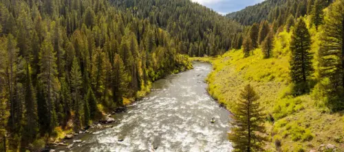 Aerial view of a raft floating down a river at Teton Valley Lodge