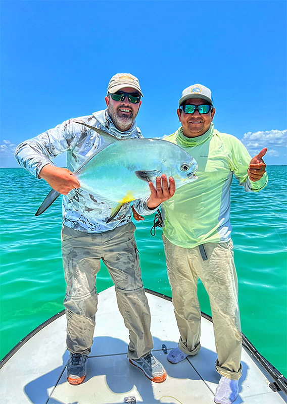 Angler and guide with a beautiful permit at ESB Lodge