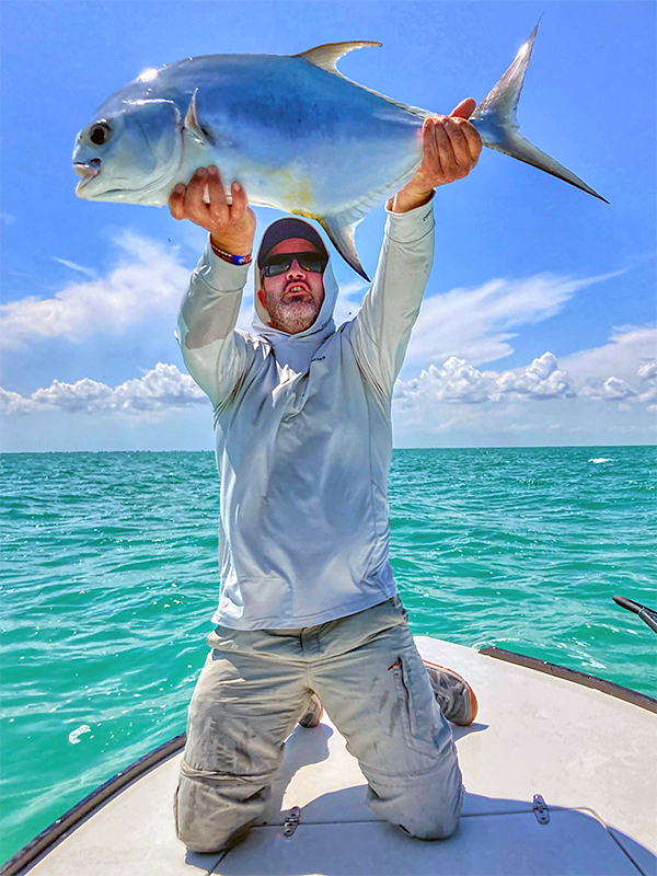 Angler raising permit towards the heavens at ESB Lodge