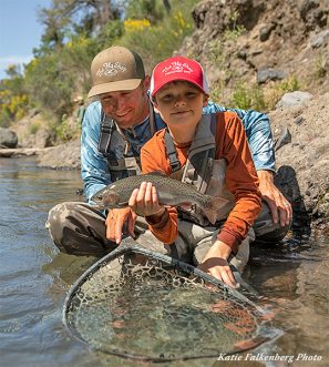 Father and son at Oasis Spring Lodge with a nice rainbow