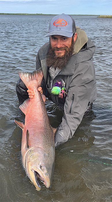Travis Ortiz with a Chinook salmon at Lava Creek Lodge in Alaska