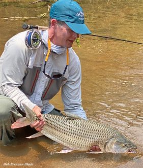 Terry Jepsen holding a tigerfish in Africa