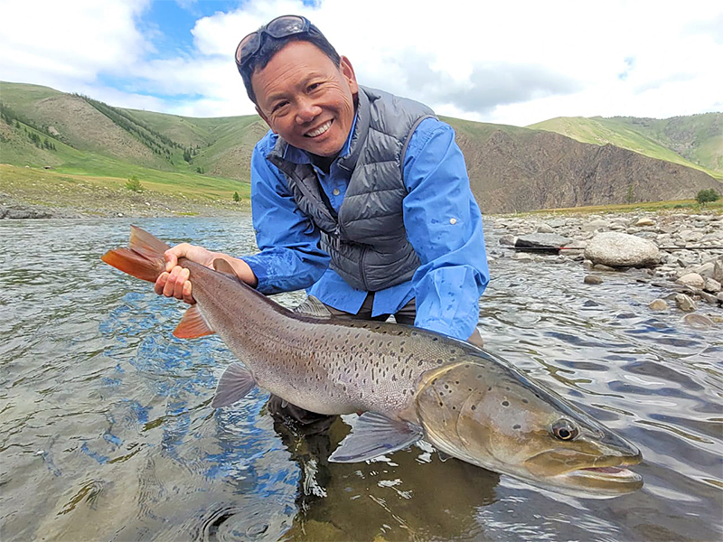 Angler holding a taimen in Mongolia
