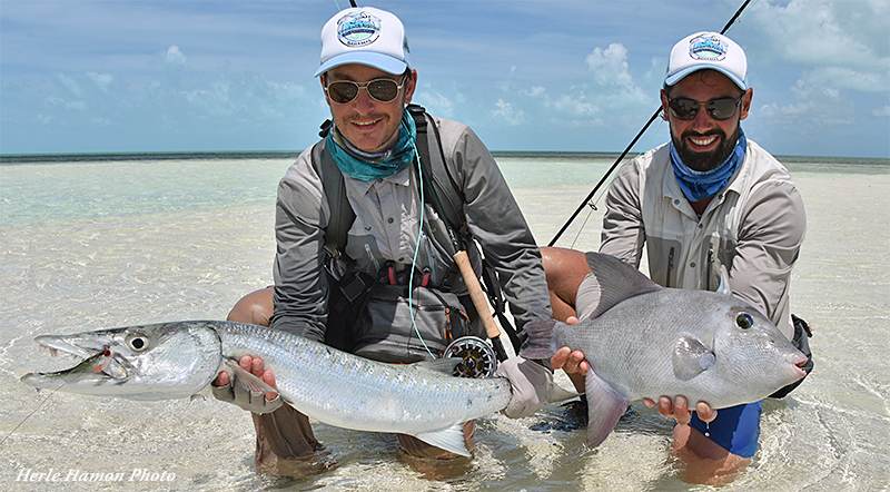 Anglers holding a barracuda and triggerfish at Crooked & Acklins lodge