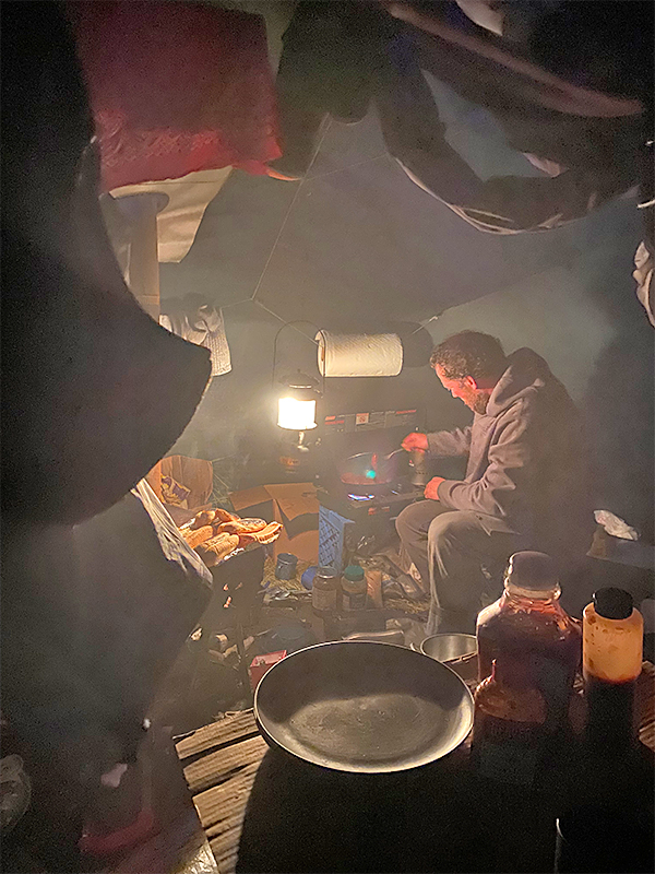 Stig at the stove in the main tent at Pinnell Creek