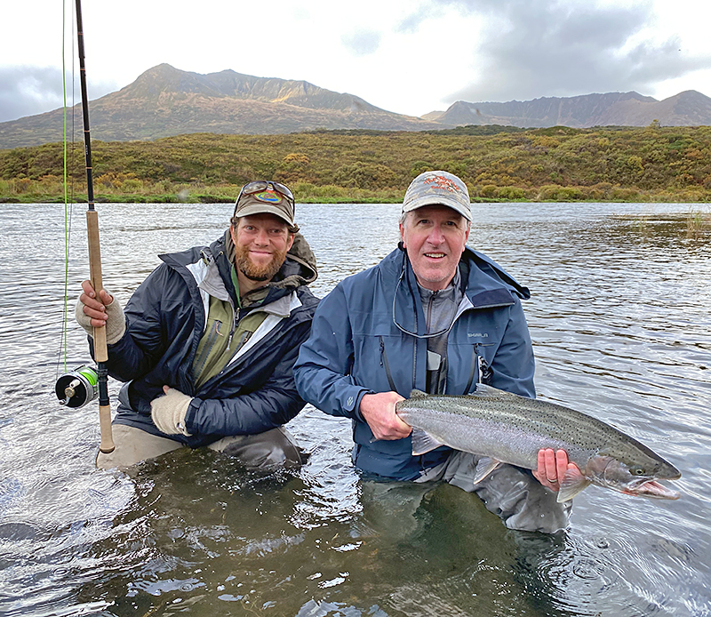 Pat Pendergast holding a wild steelhead in Alaska