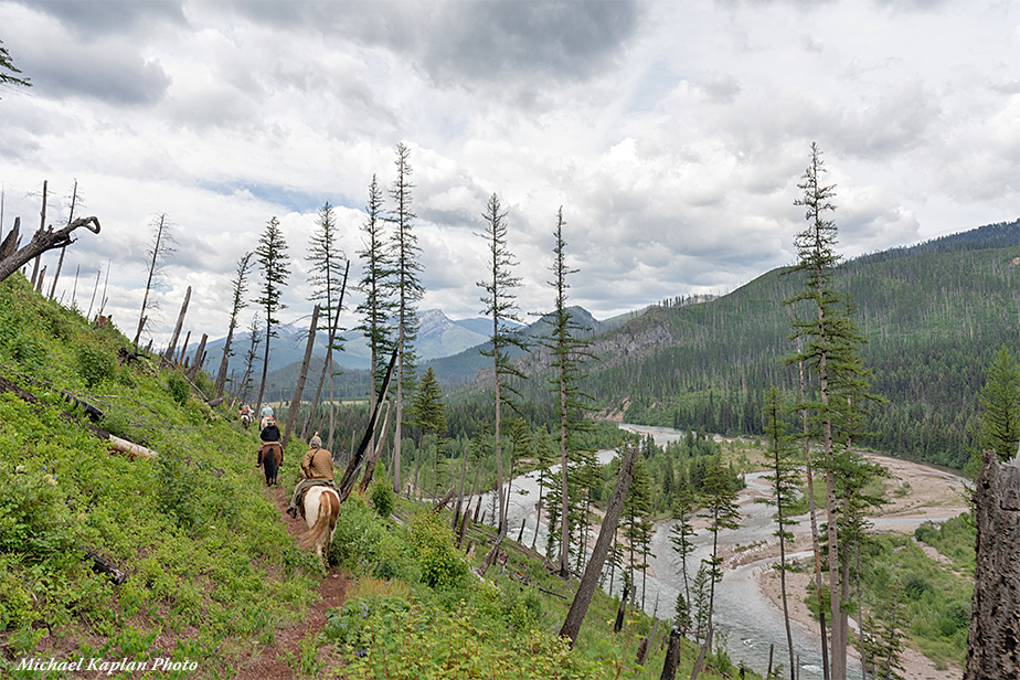 Riding horses with a beautiful view