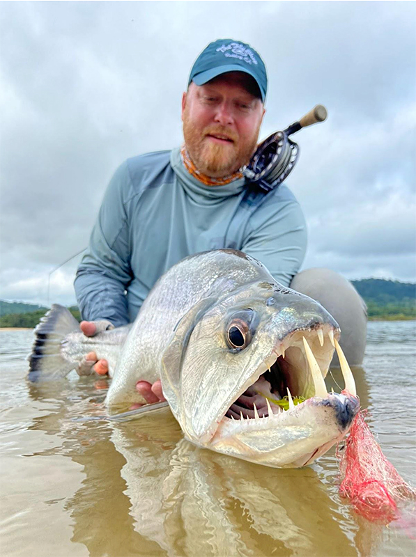 Justin Miller holding a payara in Brazil