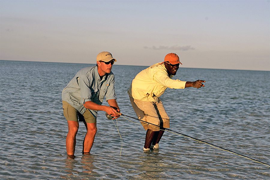 Guide pointing out fish at Andros South Lodge in the Bahamas