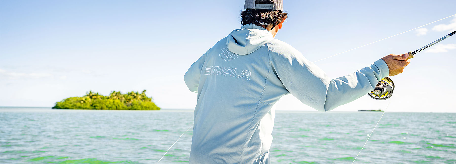 Angler casting while wearing Skwala Sol Tropic Hoody