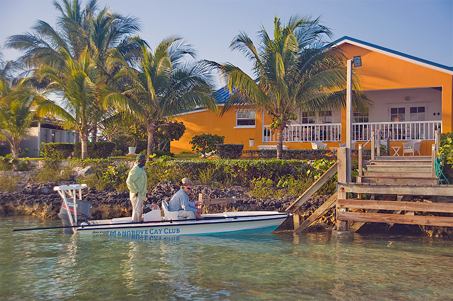 Skiff pulling up to the lodge at Mangrove Cay Club