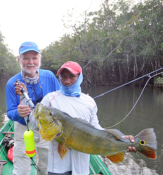 Don Causey with guide holding peacock bass in Colombia