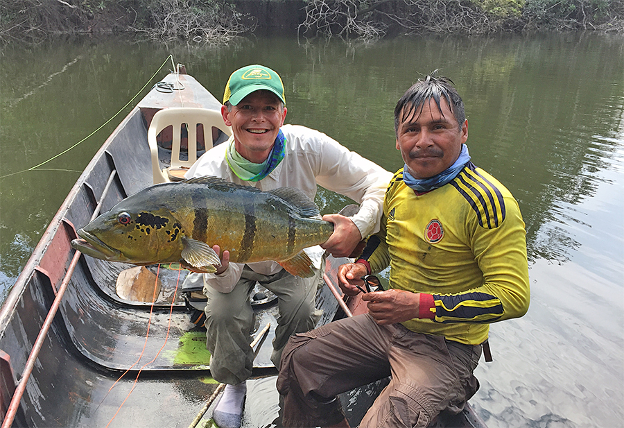 Terry Jepsen holding a peacock bass on the Mataveni River in Colombia