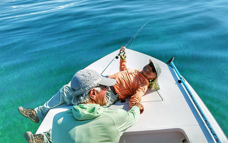 Frank Hatanaka resting on the bow after releasing his tarpon