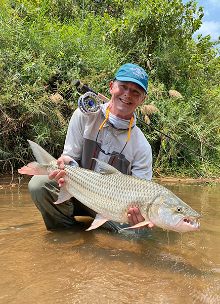 Terry Jepsen holding a tigerfish in Tanzania