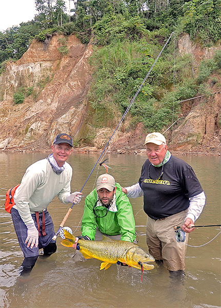 Mike Michalak and Terry Jepsen with guide holding golden dorado