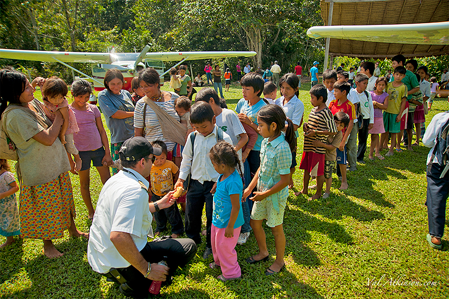 Pilots handing out bread to villagers - Val Atkinson Photo