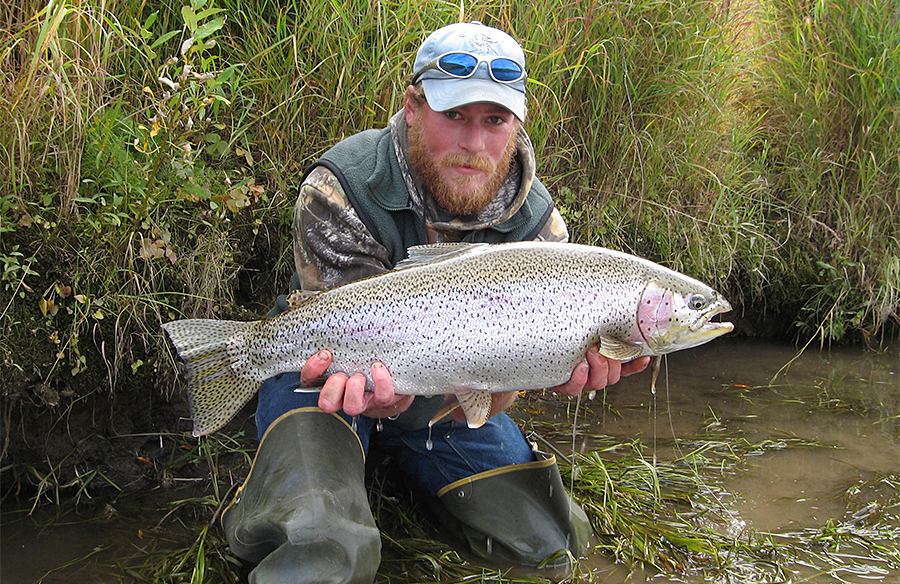 Angler with large rainbow trout at Outpost on the Nush