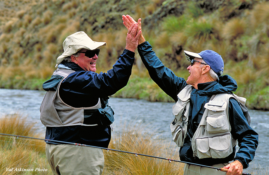 Two anglers giving a high five in New Zealand