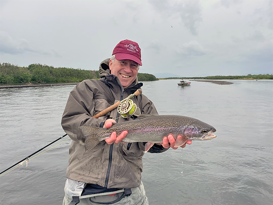 Mike Mercer holding a rainbow trout at Lava Creek Lodge