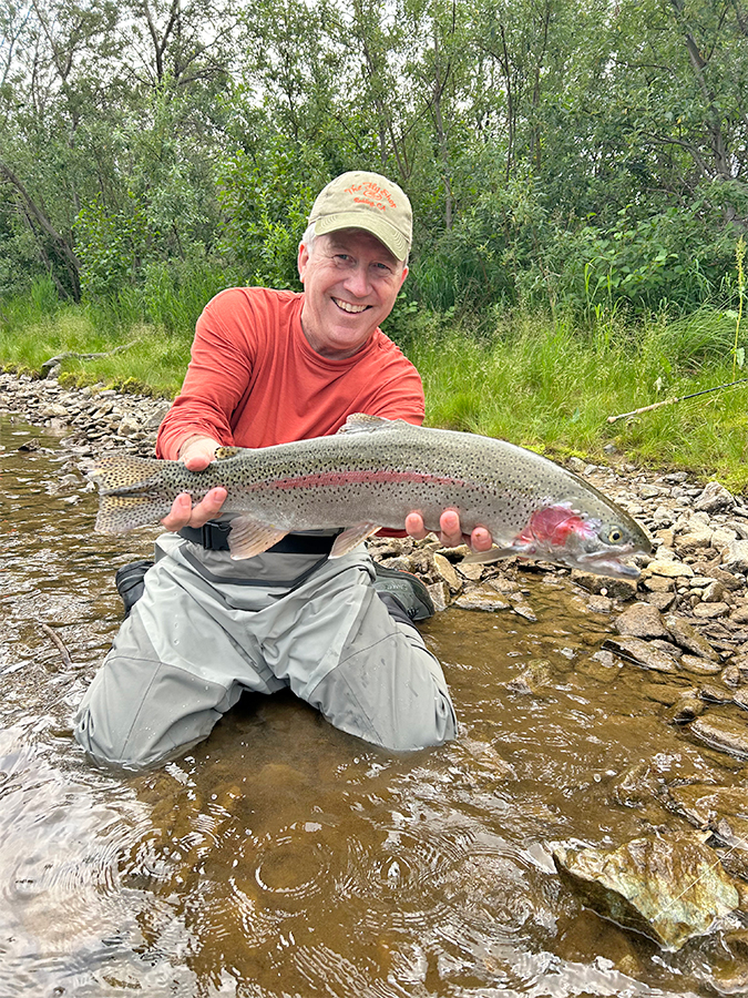 Mike Mercer holding a leopard rainbow trout on the Gibraltar River