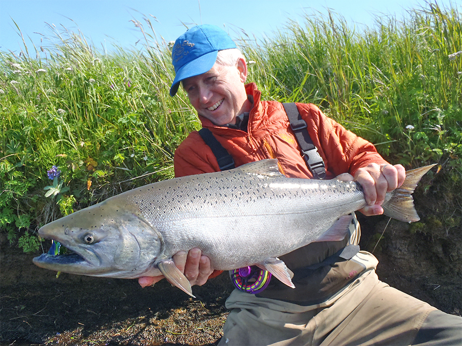 Mike Mercer holding a King salmon at Lava Creek Lodge