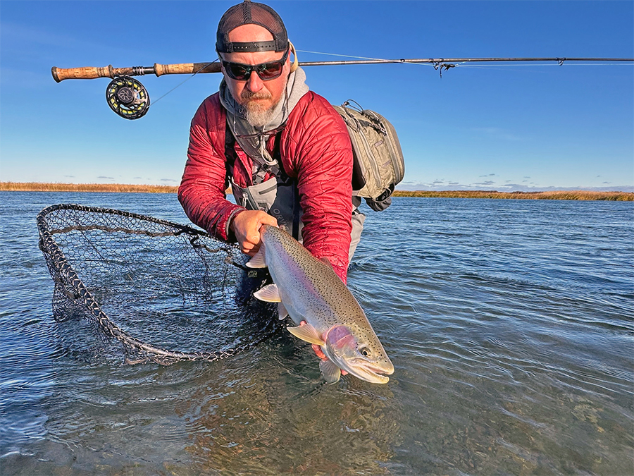 Angler with a big Alaska rainbow trout