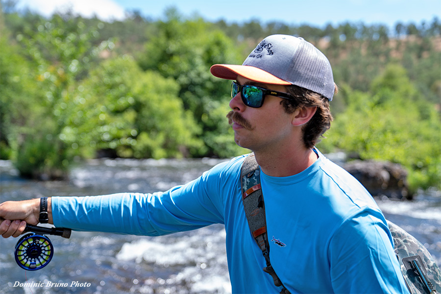 Jordan Taylor (JT) wearing sunglasses while fly fishing