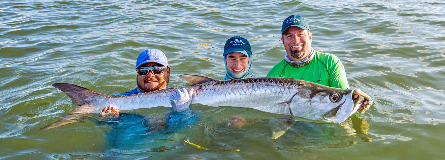 Michael & Mitchell Caranci in Belize holding a large tarpon
