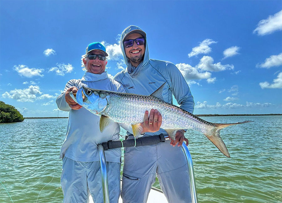 Father and son holding a tarpon at ESB Lodge