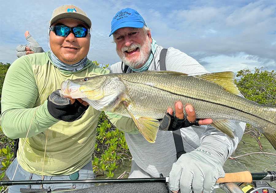 Guide and angler holding a snook at ESB Lodge