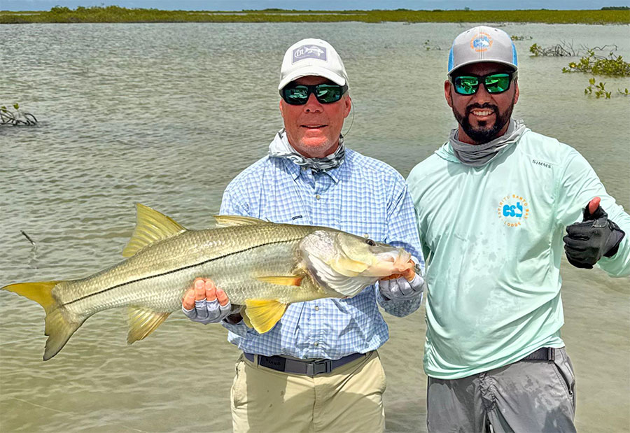 Guide and angler holding a snook at ESB Lodge