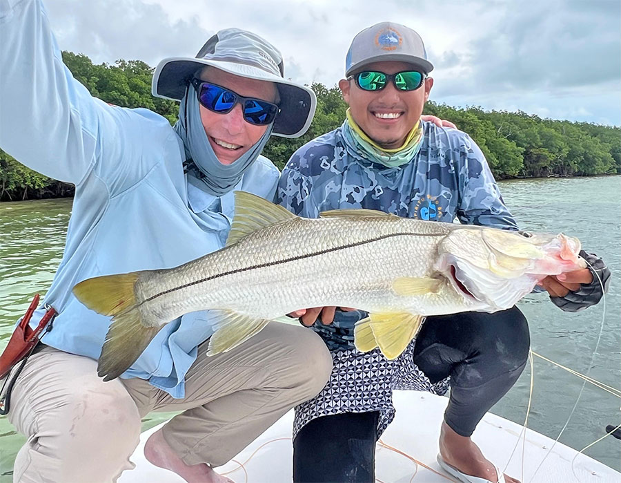 Angler and guide holding a snook at ESB Lodge
