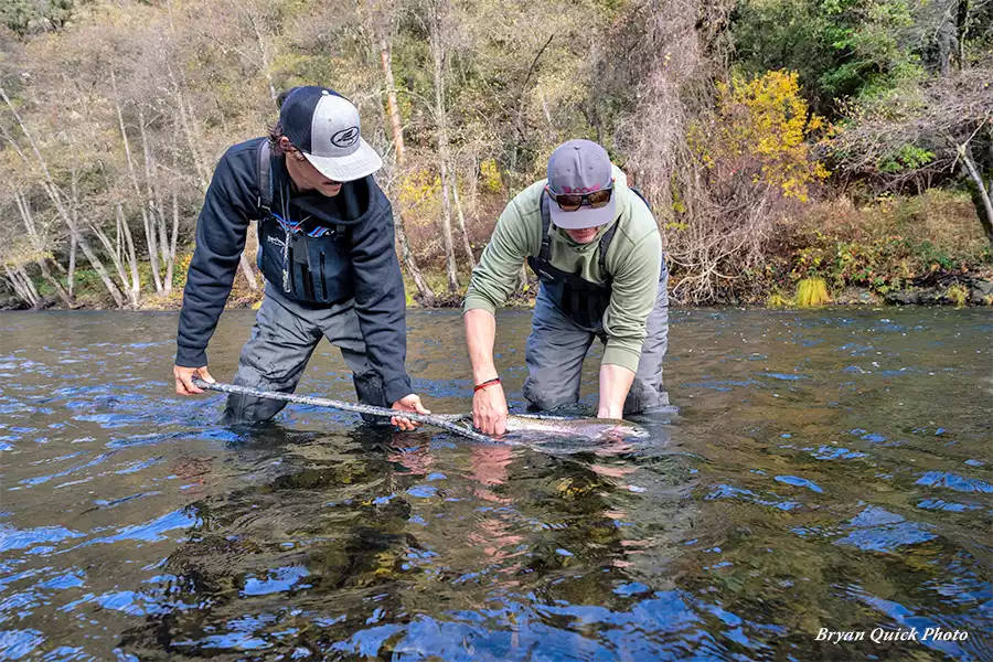 Brian Flint netting a fish on the Trinity River