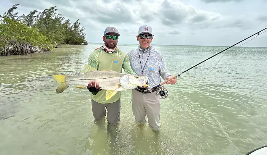 Guide and angler holding a snook at ESB Lodge