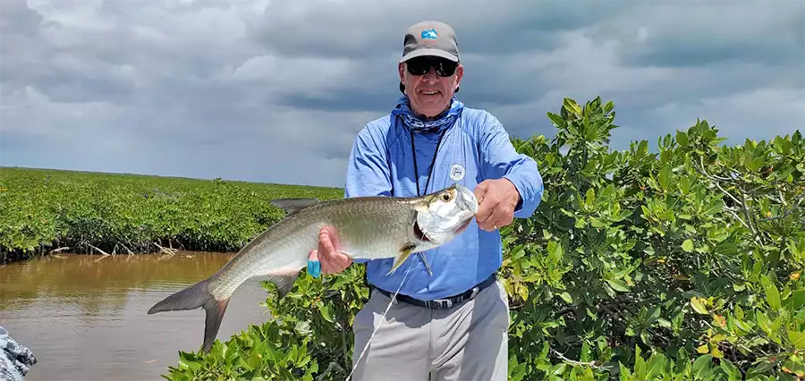 Angler holding a tarpon at ESB Lodge