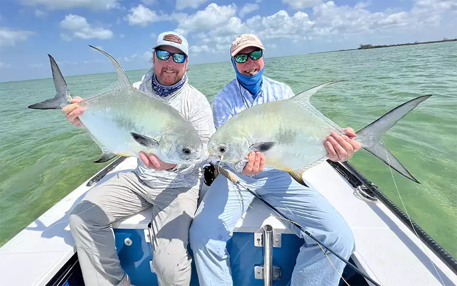 Anglers holding permit in the skiff at ESB Lodge