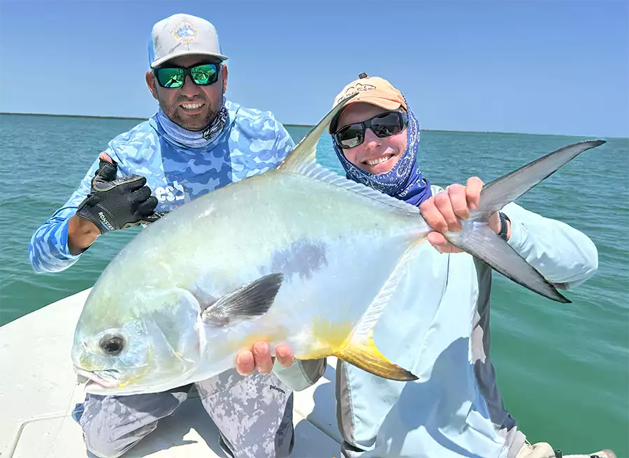 Angler and guide holding a permit at ESB Lodge