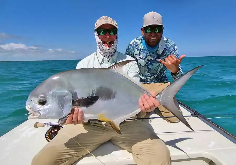 Angler and guide holding a permit at ESB Lodge