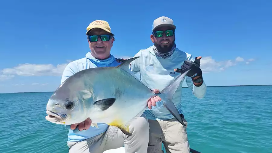 Angler and guide holding a permit at ESB Lodge
