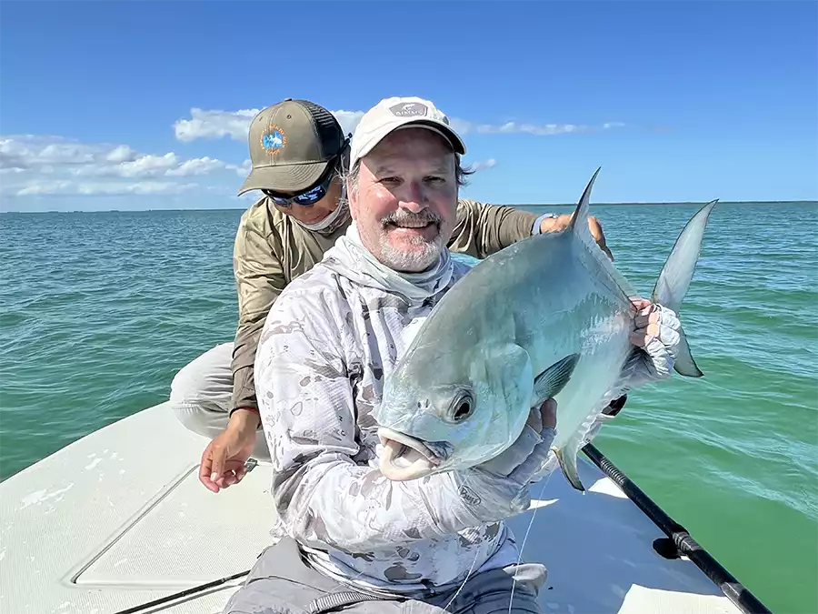 Angler holding a permit at ESB Lodge