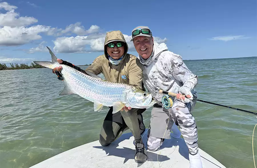 Angler and guide holding a tarpon at ESB Lodge
