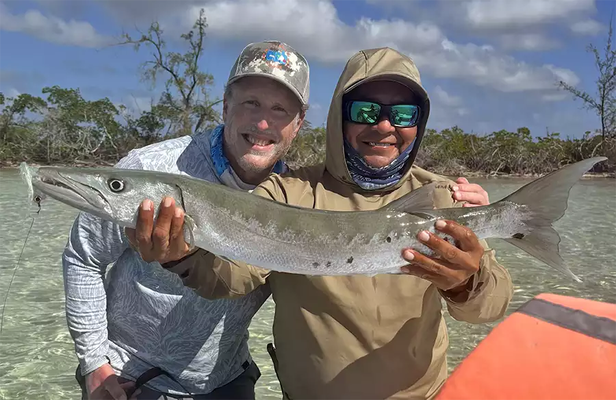 Guide and angler holding a barracuda at ESB Lodge