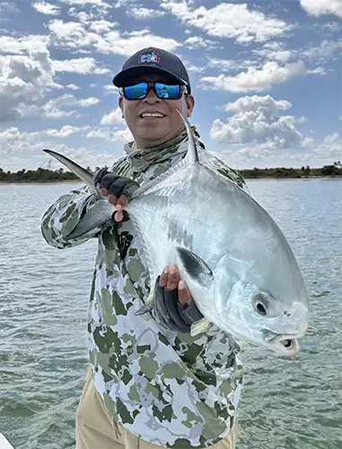 Guide holding a permit at ESB Lodge
