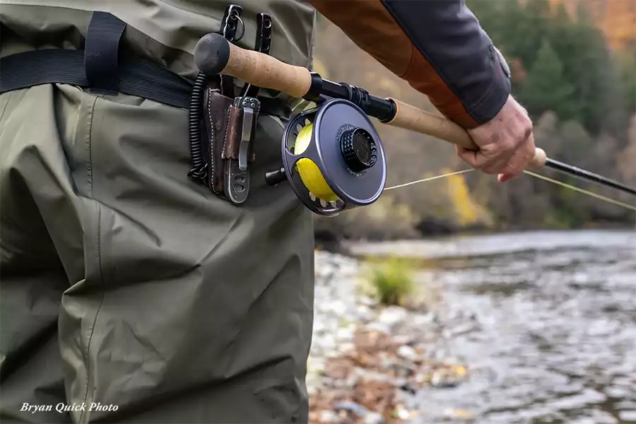Angler holding a Galvan Swing reel on the Trinity River
