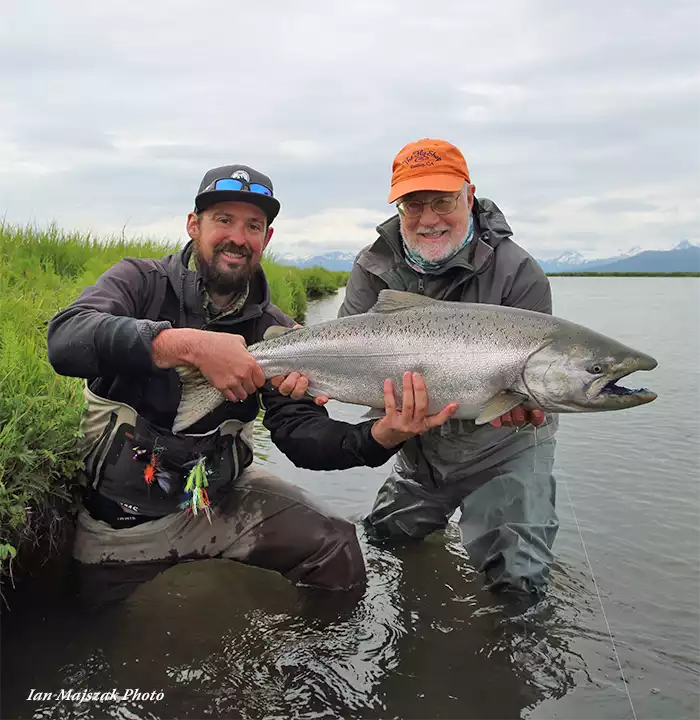 Guide and angler holding a Chinook salmon at Lava Creek Lodge