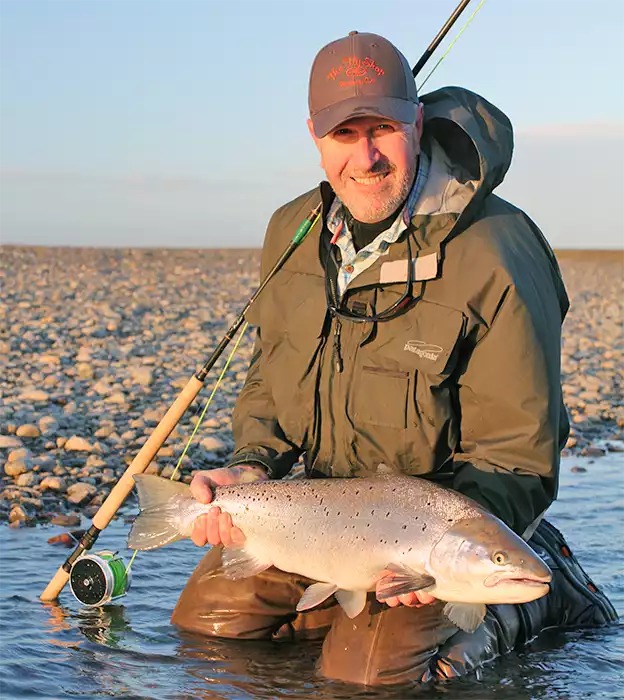 Pat Pendergast holding a sea run brown trout at Estancia Maria Behety